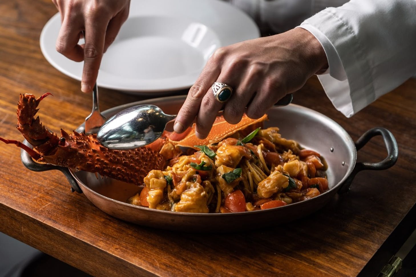 Chef plating up fresh fine dining seafood.